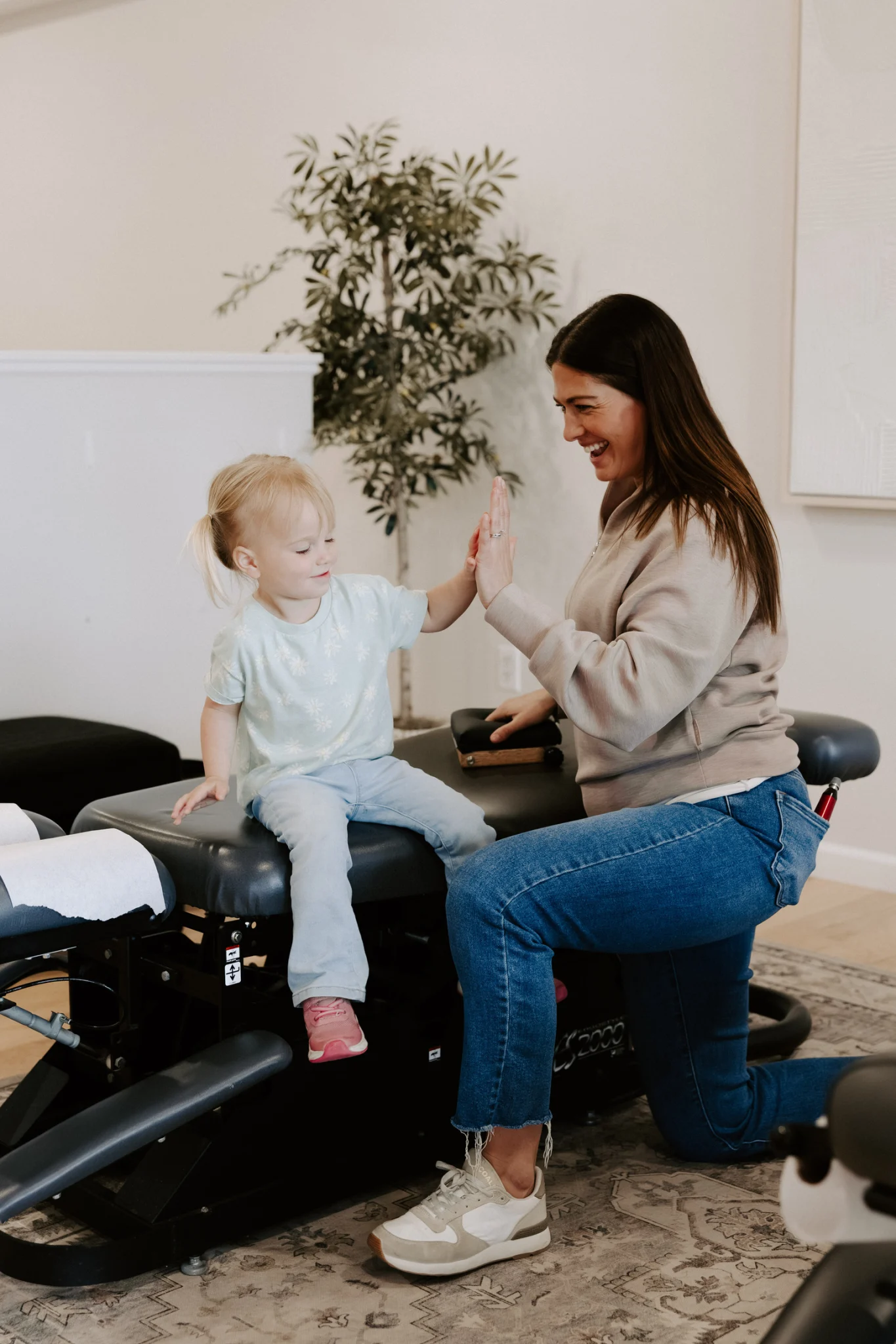 Wellhouse Chiropractic consultation with a mother and baby